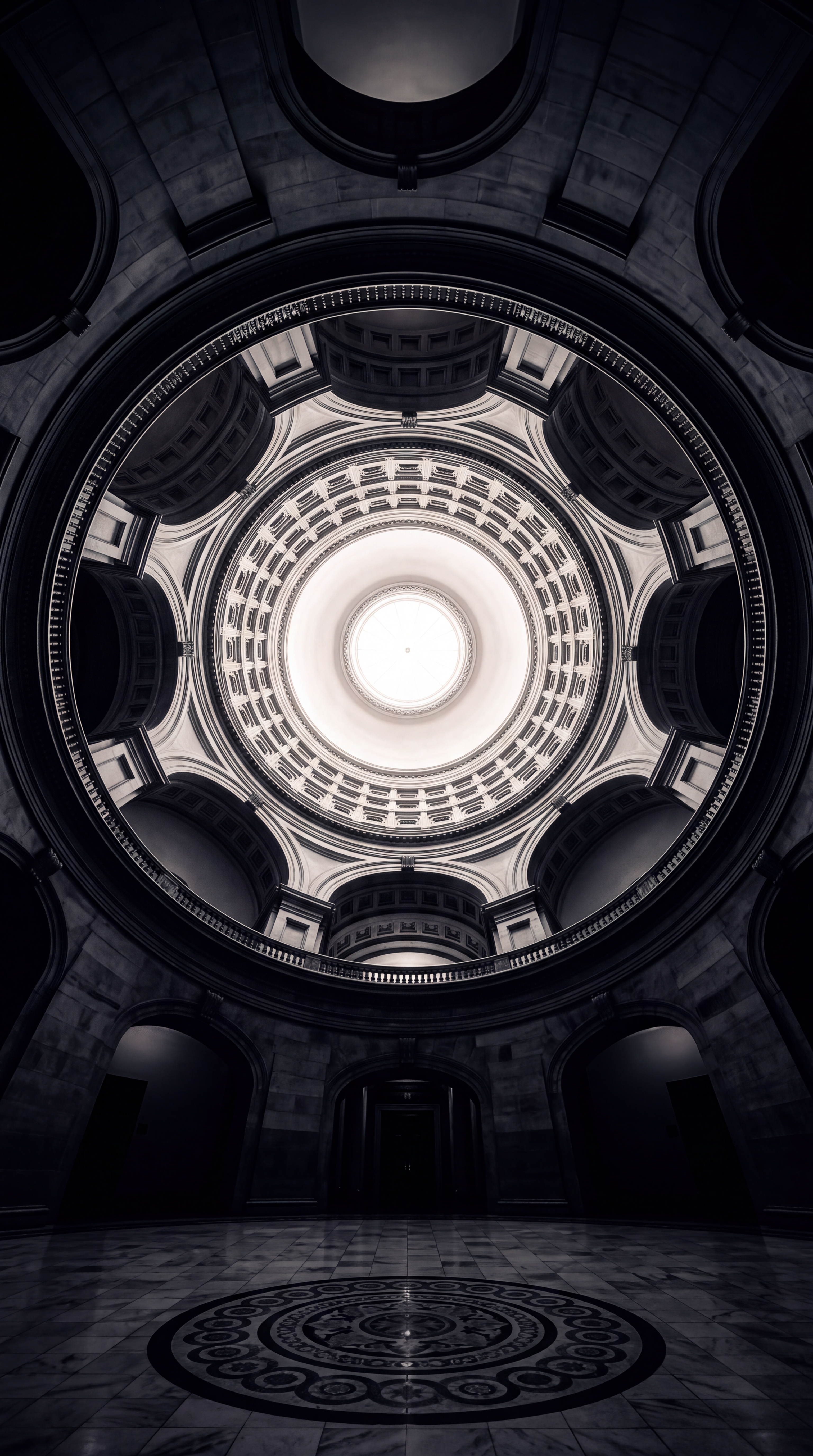 A circular view of a dome with intricate architectural details.