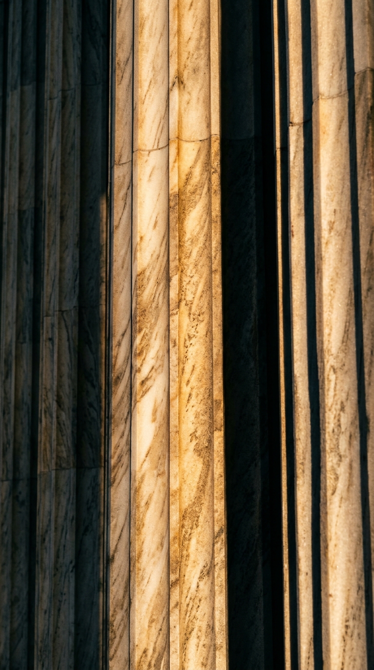 The image shows the textured surface of marble columns with shadows.