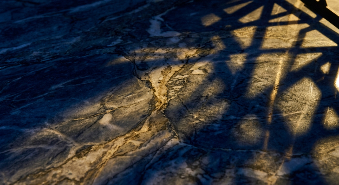 A close-up view of a textured stone surface with shadows cast on it.