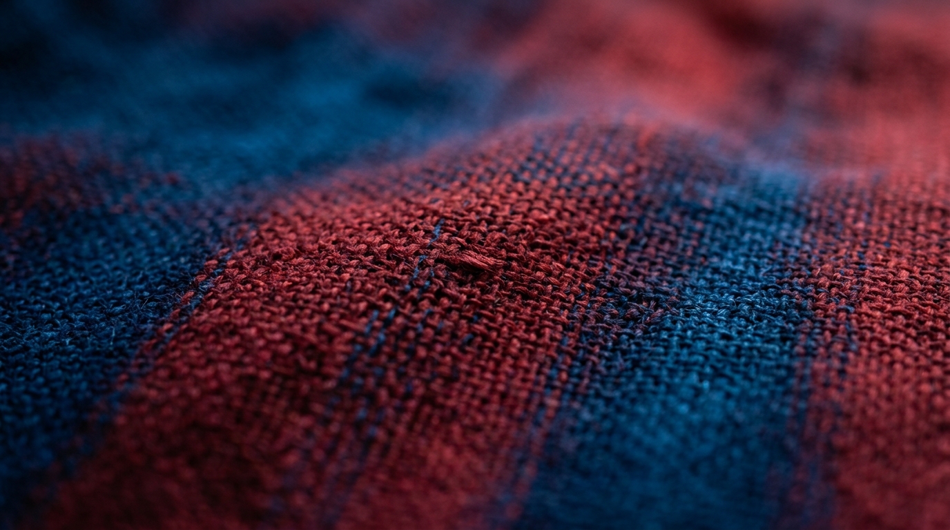 A close-up view of a textured fabric with red and blue patterns.