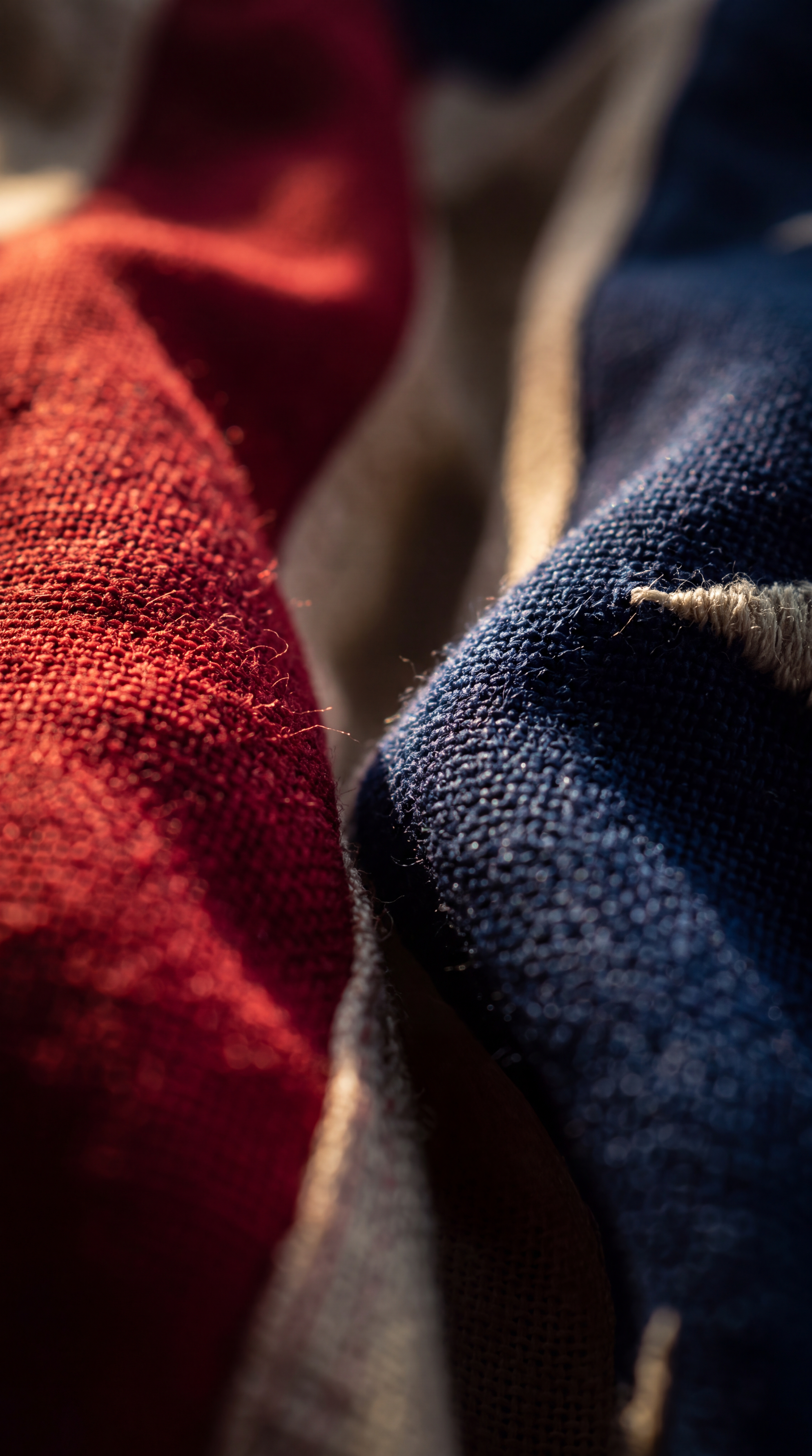 A close-up of textured fabric in red and blue colors.