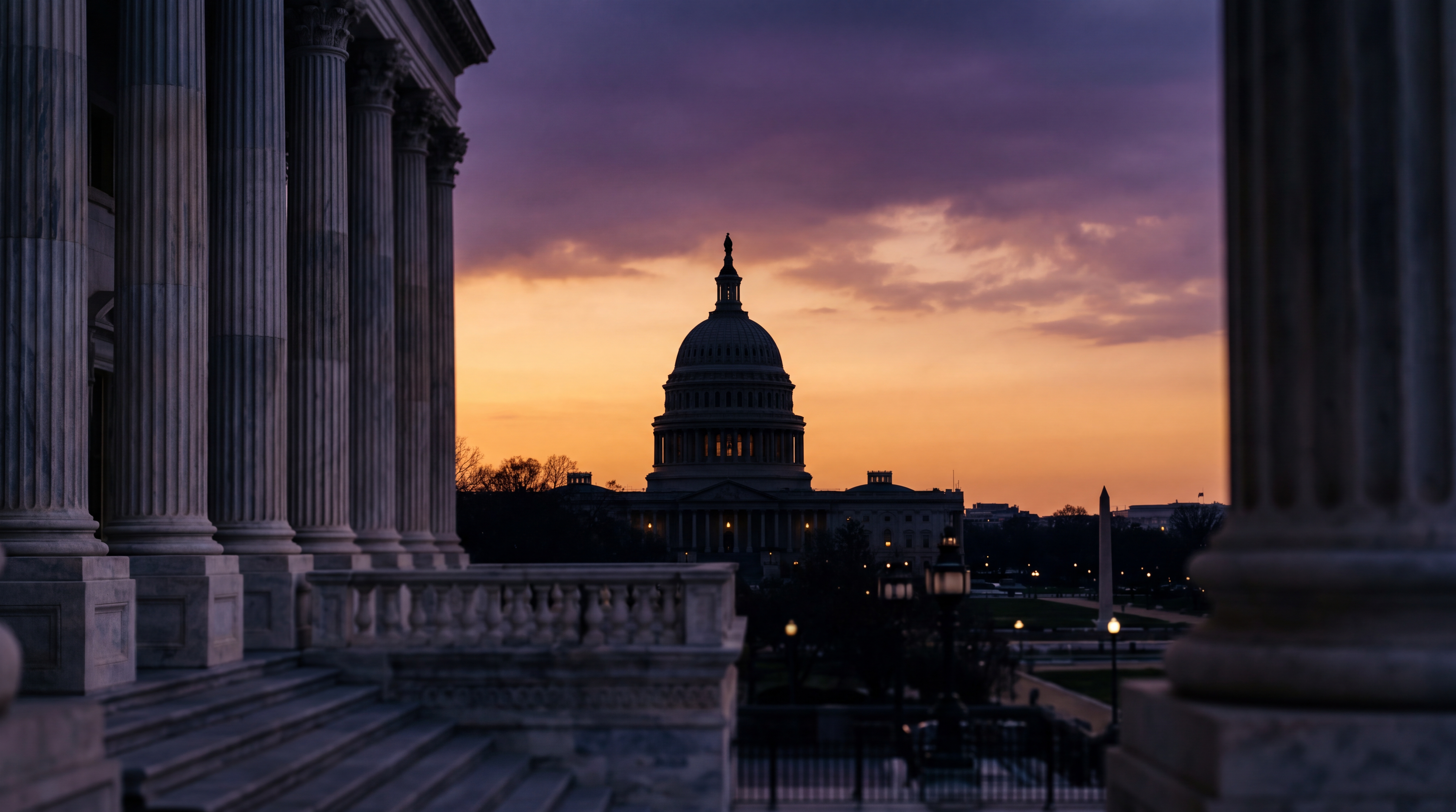 The image shows the United States Capitol building silhouetted against a colorful sunset.