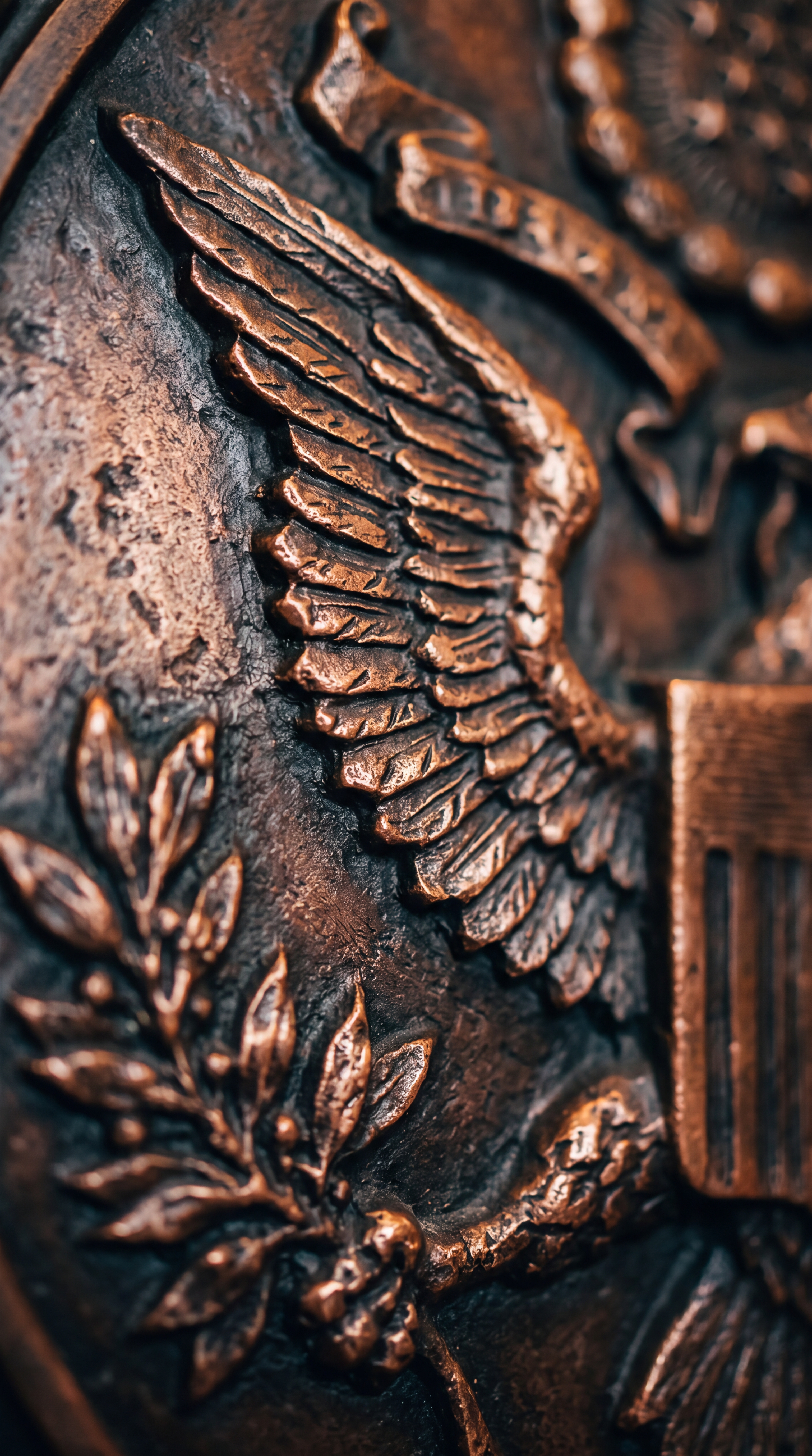 A close-up of a bronze emblem featuring an eagle and olive branches.