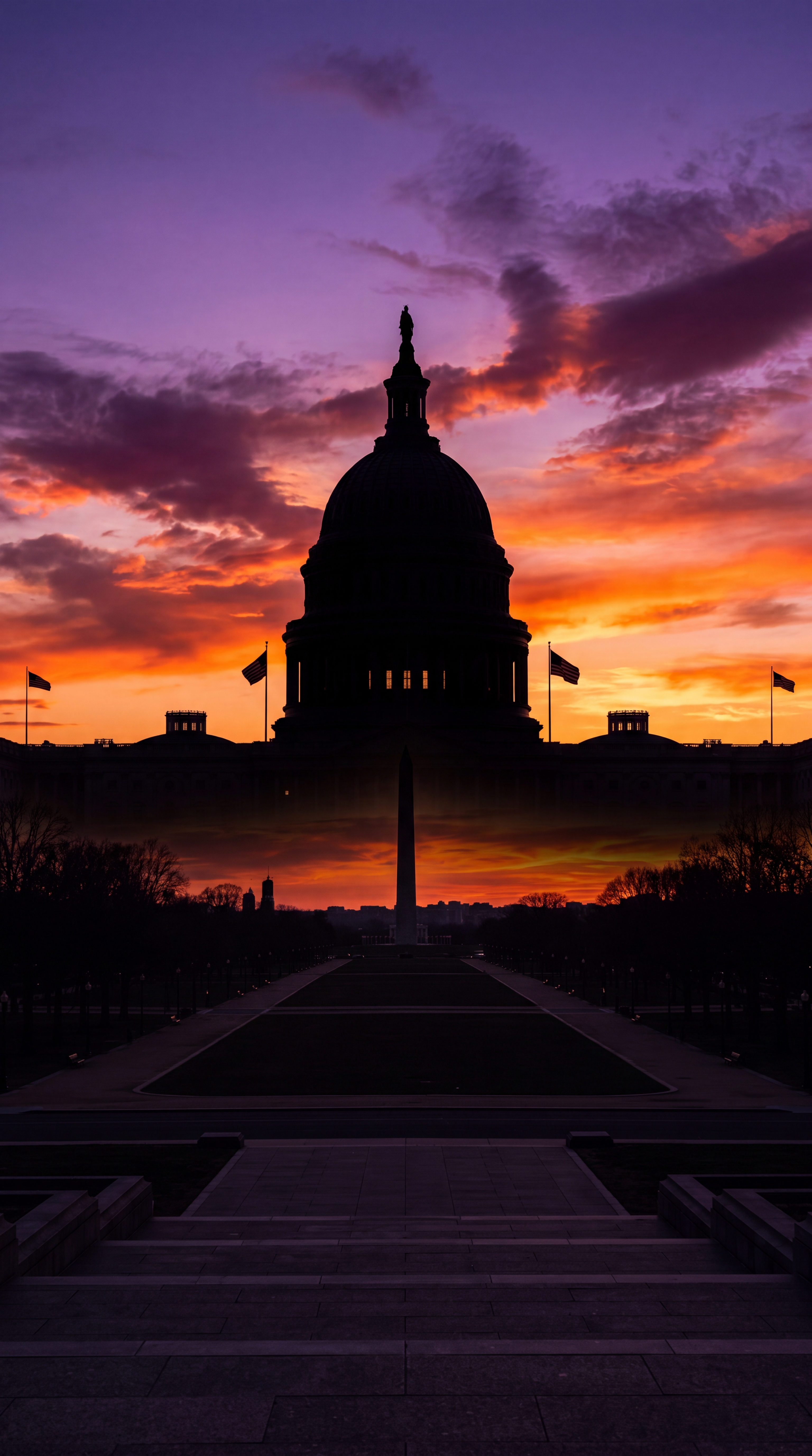 A silhouette of a capitol building against a colorful sunset sky.