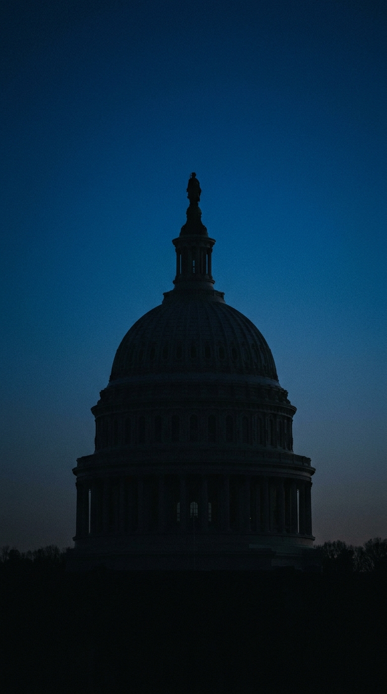 The silhouette of a large dome structure against a twilight sky.